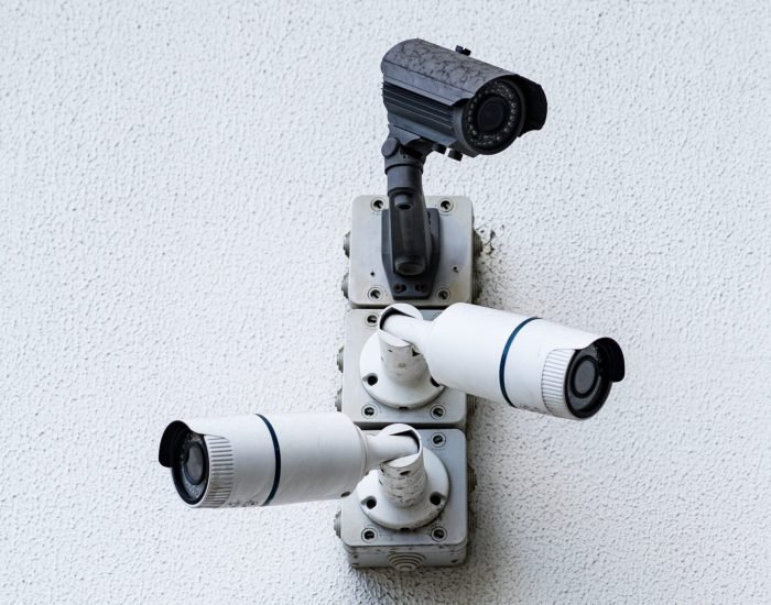 Security cameras on white modern building, technology concept